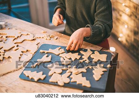 Mid section of boy preparing Christmas cookies at kitchen counter View Large Photo Image Stock Image - Mid section of boy preparing Christmas cookies at kitchen counter. Fotosearch