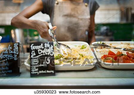 Mid section of waitress serving salad from cafe display cabinet View Large Photo Image Stock Image - Mid section of waitress serving salad from cafe display cabinet. Fotosearch