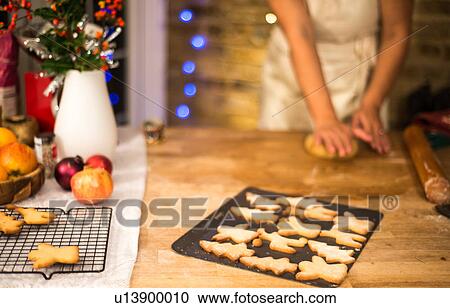 Mid section of woman flattening Christmas cookie pastry at kitchen counter View Large Photo Image Stock Image - Mid section of woman flattening Christmas cookie pastry at kitchen counter. Fotosearch