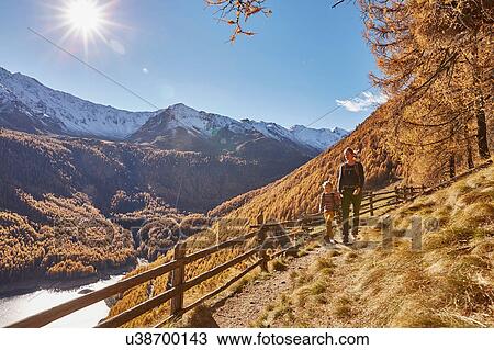 Mother and son hiking along pathway, Schnalstal, South Tyrol, Italy View Large Photo Image Stock Image - Mother and son hiking along pathway, Schnalstal, South Tyrol, Italy. Fotosearch