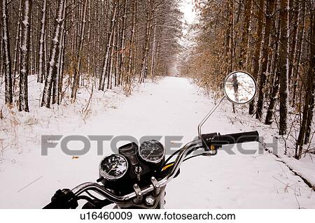 Stock Photo - Motorbike parked in snowy forest. Fotosearch