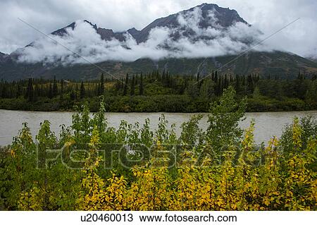 Mountain, river and clouds view in Autumn, off Richardson Highway, Route 4, North of Paxon, Alaska View Large Photo Image Stock Image - Mountain, river and clouds view in Autumn, off Richardson Highway, Route 4, North of Paxon, Alaska. Fotosearch
