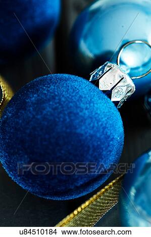 Picture - Overhead view of blue velvet Christmas baubles. Fotosearch