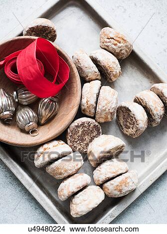 Picture - Overhead view of Christmas baubles, red ribbon with tray of scones. Fotosearch