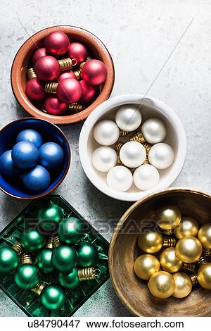 Stock Photo - Overhead view of colorful Christmas baubles in bowls. Fotosearch