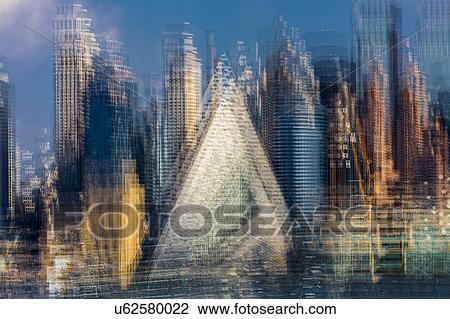 Stock Image - Painterly Impressionistic view of Midtown New York City Skyline - multiple exposures creates art view of Hell's Kitchen Pyramid. Fotosearch