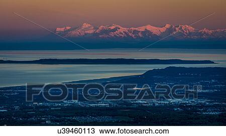 Stock Image - Panoramic View Overlooking Anchorage Alaska at sunrise. Fotosearch