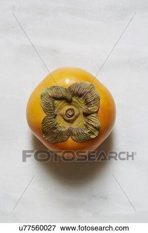 Persimmon against white background View Large Photo Image Stock Photo - Persimmon against white background. Fotosearch
