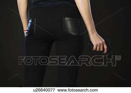 Stock Photo - Person holding a handgun. Fotosearch
