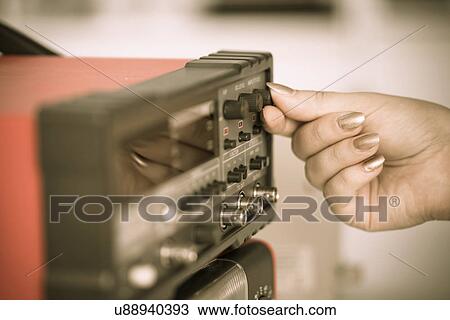 Stock Image - Person turning a dial on a telephone receiver. Fotosearch