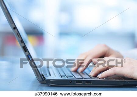Stock Photograph - Person using laptop. Fotosearch