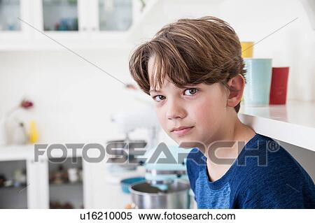 Portrait of boy sitting on kitchen work surface View Large Photo Image Stock Photography - Portrait of boy sitting on kitchen work surface. Fotosearch