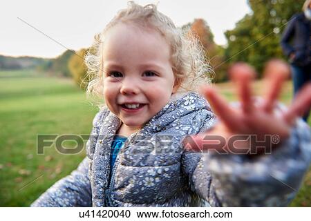 Portrait of cute female toddler in autumn park View Large Photo Image Stock Image - Portrait of cute female toddler in autumn park. Fotosearch