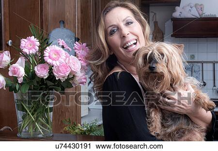 Portrait of mature woman and her dog in traditional kitchen View Large Photo Image Stock Image - Portrait of mature woman and her dog in traditional kitchen. Fotosearch