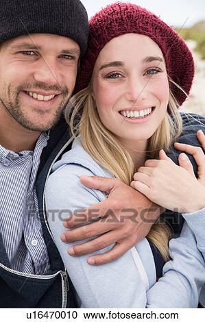 Stock Image - Portrait of romantic young couple on beach, Western Cape, South Africa. Fotosearch