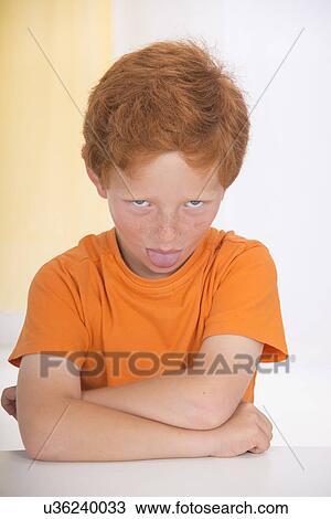 Portrait of rude boy sticking tongue out View Large Photo Image Stock Image - Portrait of rude boy sticking tongue out. Fotosearch