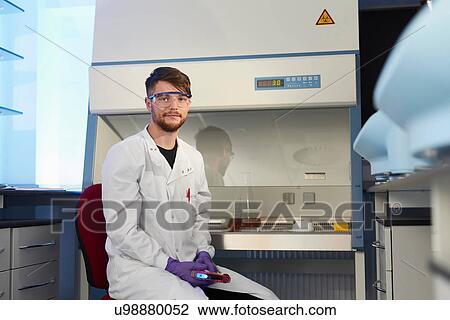 Stock Image - Portrait of scientist in laboratory looking at camera. Fotosearch