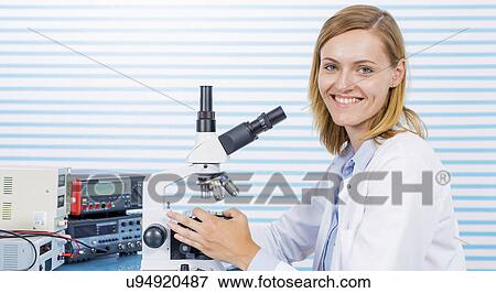 Stock Photo - Portrait of woman with microscope. Fotosearch