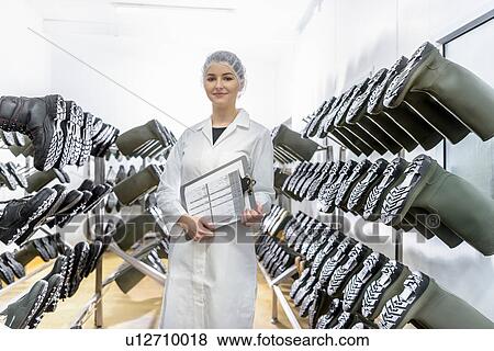 Stock Photo - Portrait of worker in clean clothes changing room in Asian food factory. Fotosearch