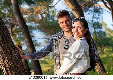 Stock Photography - Portrait of young couple in forest, Split, Dalmatia, Croatia. Fotosearch