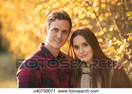 Stock Image - Portrait of young couple in rural setting. Fotosearch