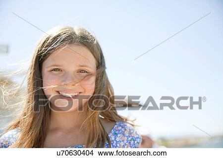 Picture - Portrait of young girl by sea. Fotosearch