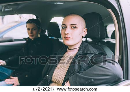 Stock Photo - Portrait of young lesbian couple sitting in car. Fotosearch