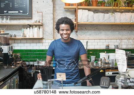 Stock Photo - Portrait of young male waiter in cafe. Fotosearch