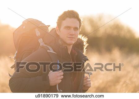 Portrait of young man hiking in rural setting View Large Photo Image Stock Photo - Portrait of young man hiking in rural setting. Fotosearch