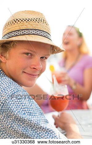 Portrait of young man with wine at waterfront restaurant, Majorca, Spain View Large Photo Image Stock Photo - Portrait of young man with wine at waterfront restaurant, Majorca, Spain. Fotosearch