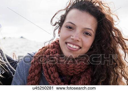 Stock Image - Portrait of young woman at beach, Western Cape, South Africa. Fotosearch
