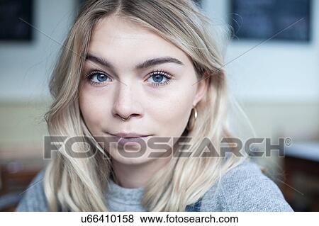 Stock Photo - Portrait of young woman, in cafe. Fotosearch