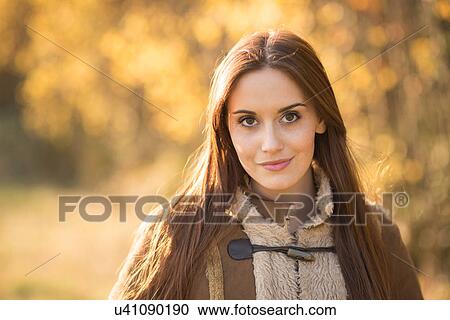 Portrait of young woman outdoors, in rural setting View Large Photo Image Stock Image - Portrait of young woman outdoors, in rural setting. Fotosearch