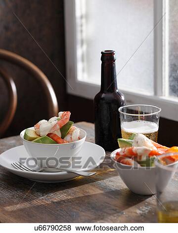 Stock Photo - Prawn cocktail and glass of beer on table. Fotosearch
