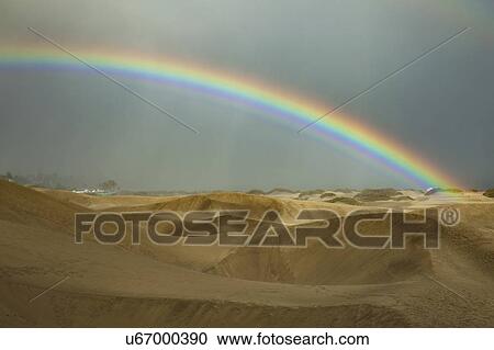Stock Image - Rainbow over desert, Utah, USA. Fotosearch