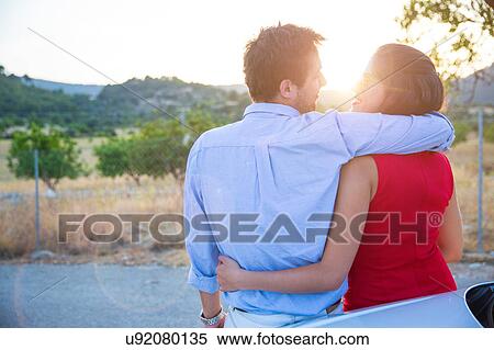 Stock Photography - Rear view of romantic young couple at sunset, Majorca, Spain. Fotosearch