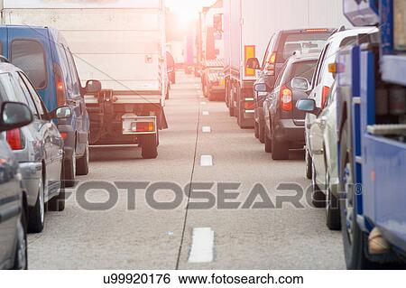 Stock Photograph - Rear view of rows of traffic queueing on highway. Fotosearch