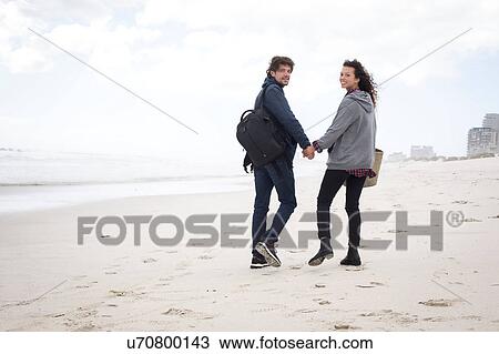 Rear view portrait of young couple strolling on beach, Western Cape, South Africa View Large Photo Image Stock Image - Rear view portrait of young couple strolling on beach, Western Cape, South Africa. Fotosearch
