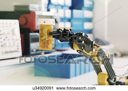 Stock Image - Robotic arm and bottle of pills. Fotosearch