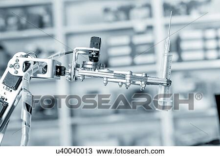 Stock Image - Robotic hand holding syringe. Fotosearch