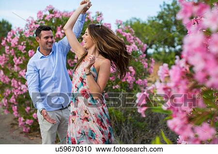 Romantic couple dancing and swirling by blossoms, Majorca, Spain View Large Photo Image Stock Image - Romantic couple dancing and swirling by blossoms, Majorca, Spain. Fotosearch