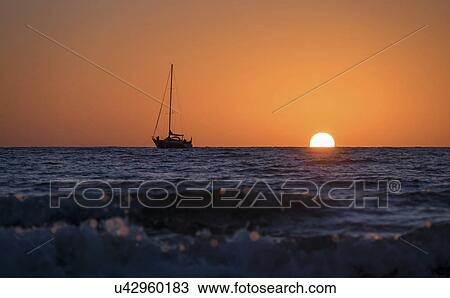 Sailboat on the ocean at sunset View Large Photo Image Stock Image - Sailboat on the ocean at sunset. Fotosearch