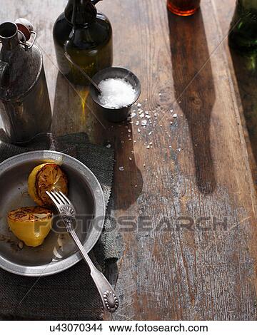 Salt and lemon on wooden table View Large Photo Image Picture - Salt and lemon on wooden table. Fotosearch