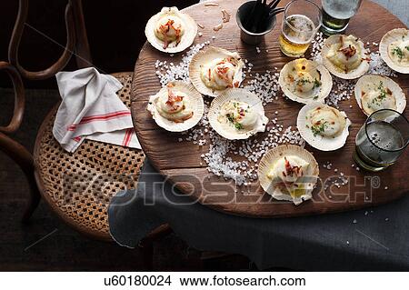 Scallops in shells on table View Large Photo Image Picture - Scallops in shells on table. Fotosearch