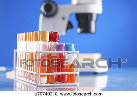 Stock Photo - Scientific samples in test tubes with microscope. Fotosearch