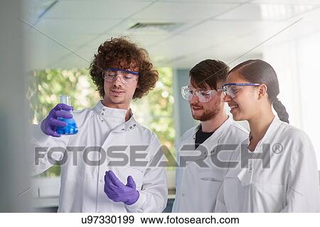 Scientist examining conical flask View Large Photo Image Stock Photo - Scientist examining conical flask. Fotosearch