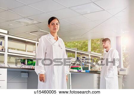 Stock Photography - Scientist in laboratory looking at camera. Fotosearch