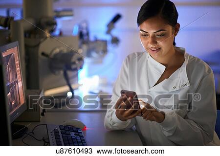 Scientist in laboratory texting on smartphone View Large Photo Image Stock Image - Scientist in laboratory texting on smartphone. Fotosearch