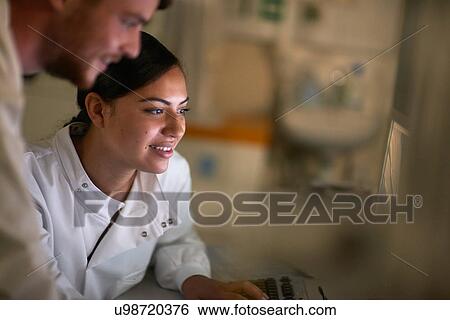 Stock Photograph - Scientist in laboratory using computer. Fotosearch