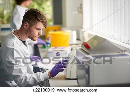 Scientist in laboratory using scientific equipment View Large Photo Image Stock Photo - Scientist in laboratory using scientific equipment. Fotosearch